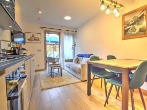 a kitchen and living room with a table and chairs at Appartement Morzine, 2 pièces, 4 personnes - FR-1-524-118 in Morzine