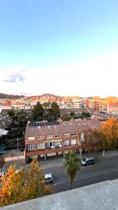 a building with cars parked in a parking lot at Dúplex con terraza by Prestigi in Terrassa +20 photos