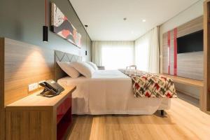 מיטה או מיטות בחדר ב-Hotel Laghetto Stilo Borges