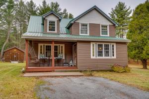 a small brown house with a green roof at Cozy Greig Getaway - 1 Mi to Brantingham Lake! in Glenfield
