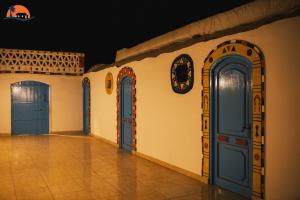 a room with blue doors on the side of a building at Nuba Narty in Aswan