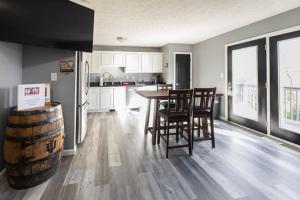 a kitchen with a table and chairs and a barrel at Lady Hoosier Retreat in Bloomington