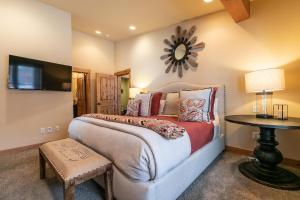 a bedroom with a bed and a table and a mirror at Trestlewood Lodge at Schaffers Mill - Gorgeous 3 BR w Golf Course Views - Extended Stays Welcome! in Truckee
