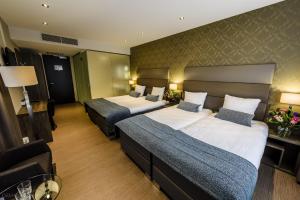Een bed of bedden in een kamer bij OZO Hotels Arena Amsterdam