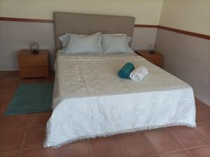 a bedroom with a bed with towels on it at Cávado Terrace Studio in Parada de Tibães