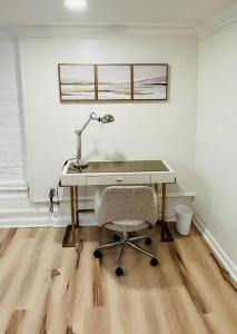 a desk with a lamp and a chair in a room at 2-Bedroom in the Heart of Denver in Denver