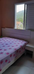 A bed or beds in a room at Apartamento para lazer com a família.