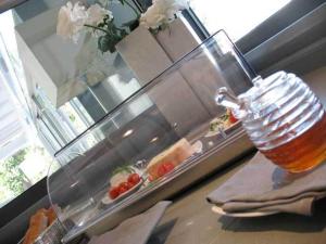 a glass of beer sitting on a table with food at Park Hotel Sporting in Teramo