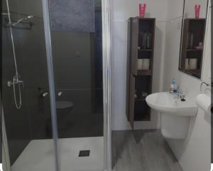 y baño con ducha y lavamanos. en Hotel Rural Aznaitín, en Albanchez de Úbeda