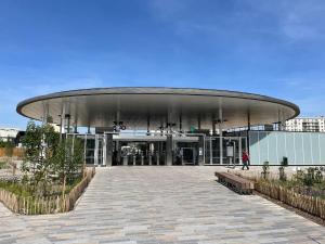 a large building with a person walking in front of it at V - Villa 2022 PARIS EXPO-3min metro-8 rooms-12 beds in Bagneux