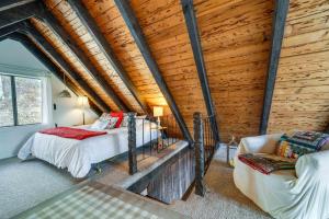 a bedroom with a bed and a couch in a room with wooden walls at Charming Soda Springs Cabin Hike, Ski and Golf! in Soda Springs