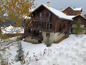 a house with snow in front of it at les chalets de puy st vincent in Puy-Saint-Vincent