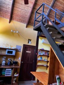 a room with a staircase and a book shelf at Las Plumas de Cabuya in Cabuya