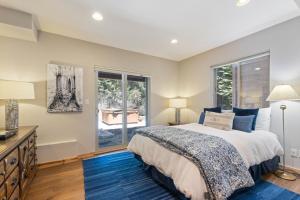 a bedroom with a bed and a window at Trailside - Alpine Meadows 6 Bedroom with Private Hot tub in Alpine Meadows