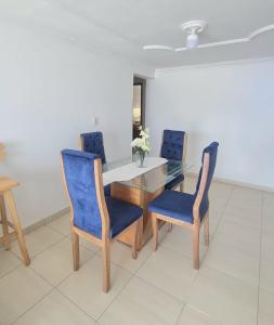 a dining room with a table and blue chairs at Acogedor y Residencial piso 3 in Cartagena de Indias