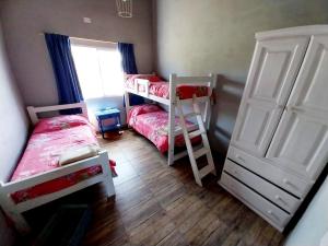 a bedroom with two bunk beds and a window at Cabaña Gota de Rocio en finca Margarita in San Rafael +18 photos