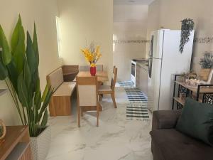 a kitchen with a table and a white refrigerator at casa em Brotas 08 in Brotas +25 photos