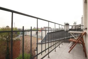 a balcony with a metal railing and a bench at Royal Apartament in Krakow