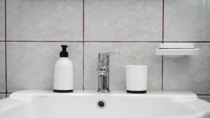 a bathroom sink with a bottle of soap on it at La casa Nikol Meteora in Kalabaka
