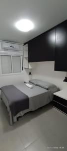 a bedroom with a large bed and a white floor at Apto 5 Estrelas no Centro de Pelotas in Pelotas