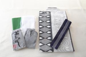 a tie and a pair of gloves on a table at Hotel Binario Saga Arashiyama in Kyoto