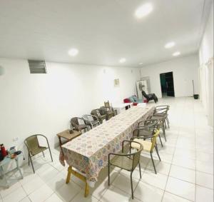a large room with a long table and chairs at Finca Los Chichelos in Santiago del Estero