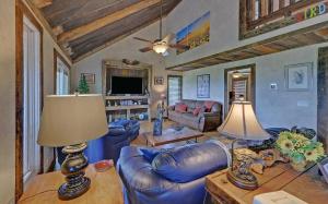 a living room with blue leather furniture and a ceiling at Birds Eye Cabin - Sunset & Starry Retreat Pet Friendly w Private HotTub, Fire Pit and Game Room in Ellijay