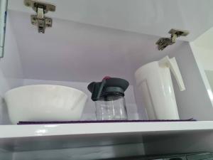 a shelf with a sink with a bottle and paper towels at Departamento Familiar en Equipetrol in Santa Cruz de la Sierra