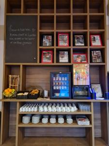 a table with cupcakes and a chalkboard on it at Enzo Hotels Loudeac By Kyriad Direct in Loudéac