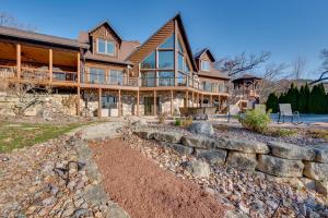 a large wooden house with a stone wall at Lake Wisconsin Lodge with Dock and Pool Near Skiing! in Merrimac