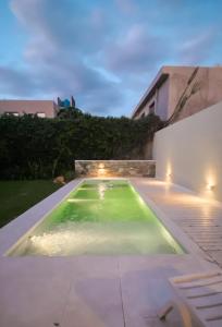 a swimming pool in the backyard of a house at Casa Feliz in San Fernando del Valle de Catamarca