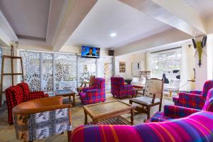 a living room with colorful chairs and a table at Tobriana in Nairobi