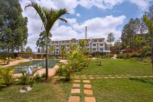 a resort with a swimming pool and a building at Tobriana in Nairobi