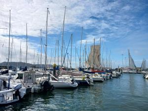 a bunch of boats docked in a harbor at Vintage Sailboat in Belém in Lisbon
