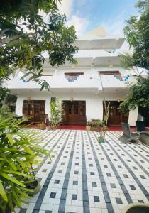 a courtyard of a building with trees in front of it at Resort of Happiness in Mirissa