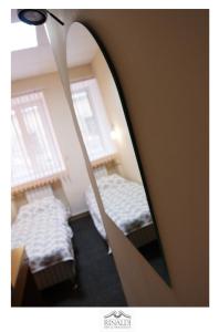 a mirror reflection of a bedroom with two beds at Rinaldi at Petropavlovskaya in Saint Petersburg