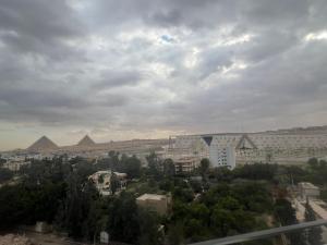 a view of a city with pyramids in the background at pyramids grand museum inn in Cairo