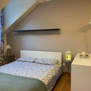a small bedroom with a bed and a staircase at Loft l'Alessandra in Bolzano