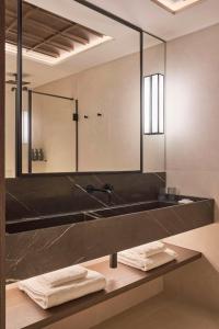 a bathroom with a black sink and a mirror at Nobu Hotel San Sebastián in Donostia-San Sebastián