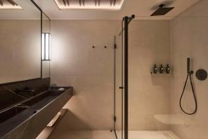 a bathroom with a shower and a sink at Nobu Hotel San Sebastián in Donostia-San Sebastián