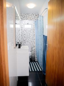 a bathroom with a sink and a toilet and a mirror at Isabela House in Ponta do Sol +83 photos