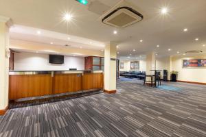a large lobby with a flat screen tv on the wall at Holiday Inn - Glasgow Airport by IHG in Paisley