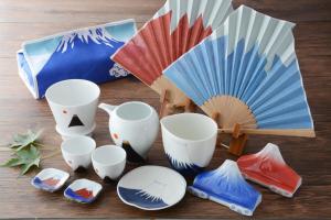 a group of cups and plates and an umbrella at Hotel Binario Saga Arashiyama in Kyoto