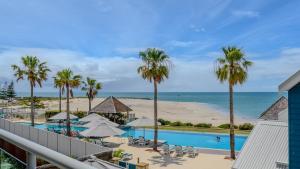 uma vista para a piscina e para a praia a partir da varanda de um resort em Sea Side 112 em Mandurah