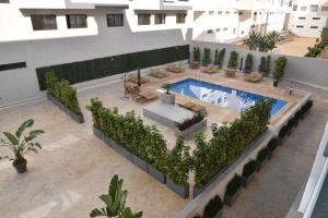 an overhead view of a swimming pool in a building at Lovely Apartment With Pool & Gym in Kenitra