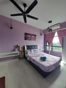 a bedroom with a bed and a ceiling fan at Jesselton Quay Rashzia Kota kinabalu in Kota Kinabalu