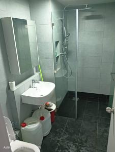 a bathroom with a shower and a toilet and a sink at Jesselton Quay Rashzia Kota kinabalu in Kota Kinabalu