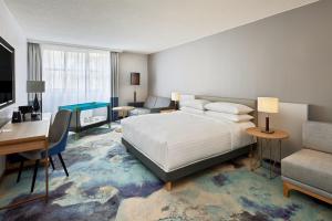 a bedroom with a bed and a desk and a couch at Hamburg Marriott Hotel in Hamburg