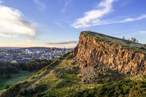 a mountain with a city in the background at 5-BR 3-BTH Newington Apartment - Modern & Spacious in Edinburgh