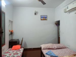 a room with a bed and a table and a mirror at Angels' homestay Marari in Mararikulam